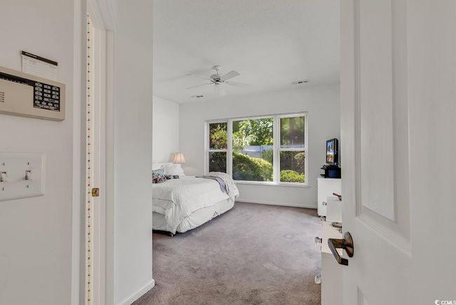 Primary bedroom featuring a ceiling fan and baseboards | Image 21