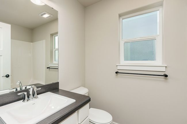 Bathroom featuring vanity, toilet, and visible vents | Image 14