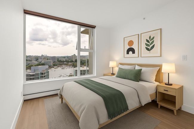 Bedroom with a baseboard heating unit and wood finished floors | Image 22