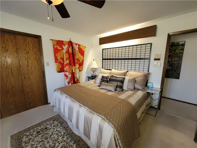 Bedroom with ceiling fan and carpet flooring | Image 45