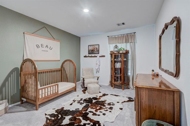 Bedroom number one has plenty of space and a beautifully colored accent wall. | Image 19