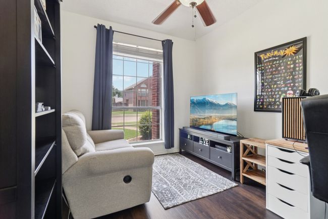 Living area with wood finished floors and a ceiling fan | Image 24