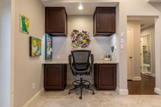 Office area featuring built in study area, light tile patterned flooring, and baseboards | Image 12