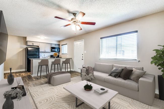 Living area with baseboards, a textured ceiling, ceiling fan, and wood finished floors | Image 4
