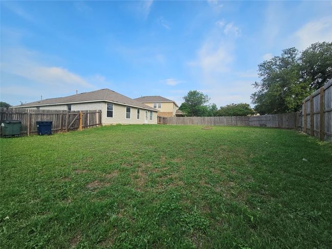 View of fenced backyard | Image 6