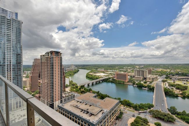 View of urban area featuring a nearby body of water and a notable bridge | Image 23