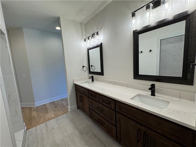 Bathroom with double vanity and wood finished floors | Image 29