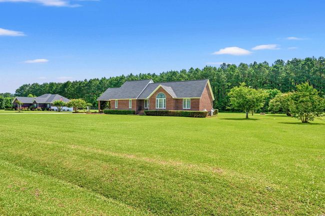 Ranch-style home with a front lawn | Image 25