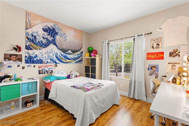 Bedroom with wood finished floors and baseboards | Image 34