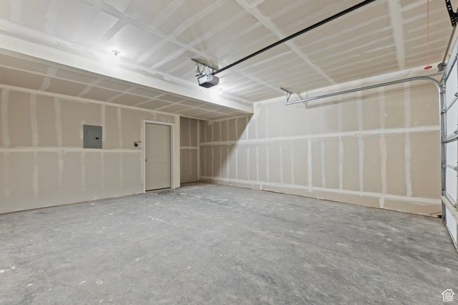 Garage featuring electric panel and a garage door opener | Image 15