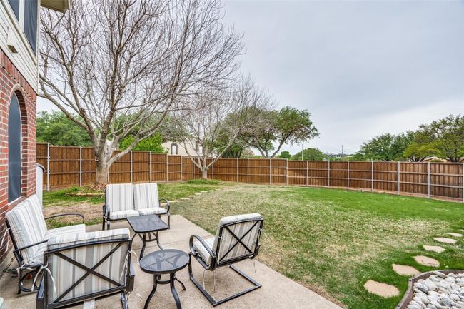Fenced backyard featuring an outdoor hangout area and a patio | Image 31