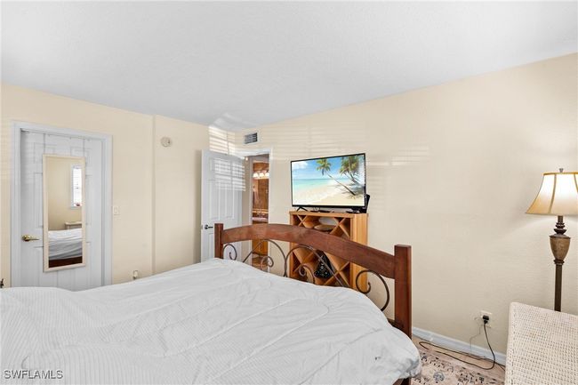 Bedroom featuring baseboards and visible vents | Image 18