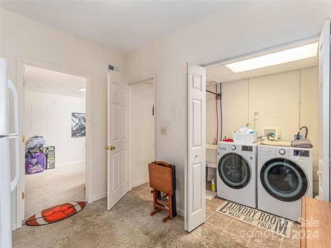 Laundry room and 1/2 bath in the basement space. | Image 19