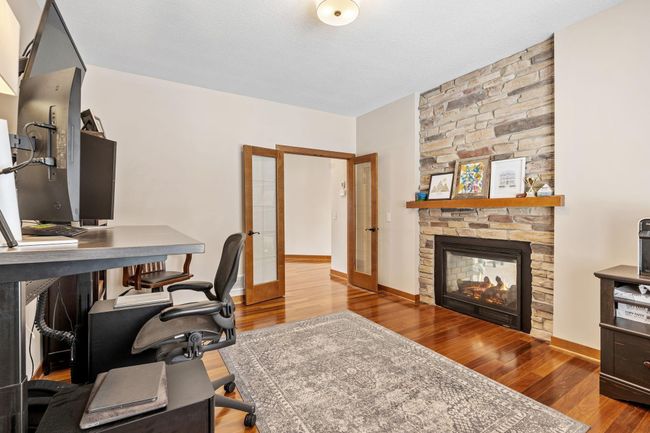 Secluded main level office space with dual sided fireplace. | Image 23