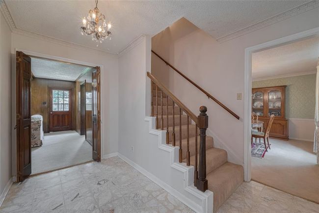 Welcome home! From the entry, enjoy easy access to the formal living room on the left, dining room on the right, and family room straight ahead. | Image 4