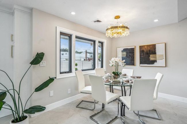 Dining space featuring recessed lighting, and a chandelier | Image 10