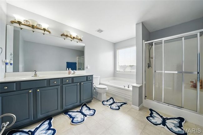 Full bathroom with a garden tub, double vanity, and an enclosed shower | Image 20