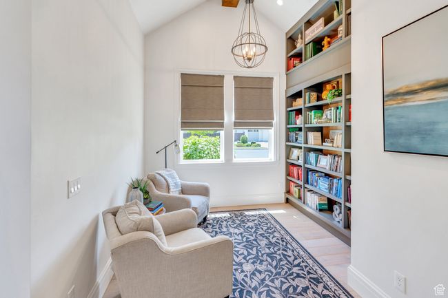 Living area with a chandelier, light wood-type flooring, and vaulted ceiling | Image 14