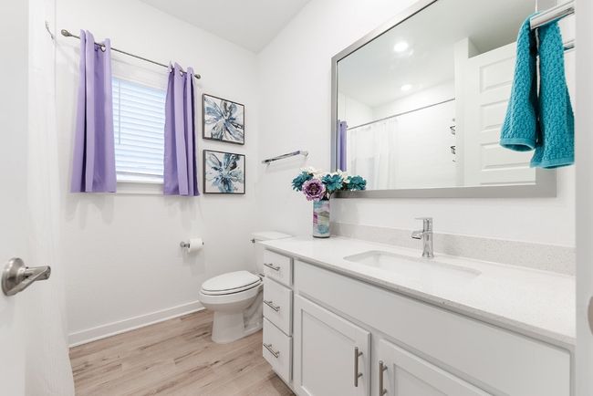 Full bathroom featuring a shower with curtain, toilet, wood finished floors, baseboards, and vanity | Image 20