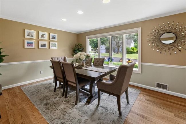 Dining room featuring ornamental molding and wood-type flooring | Image 4