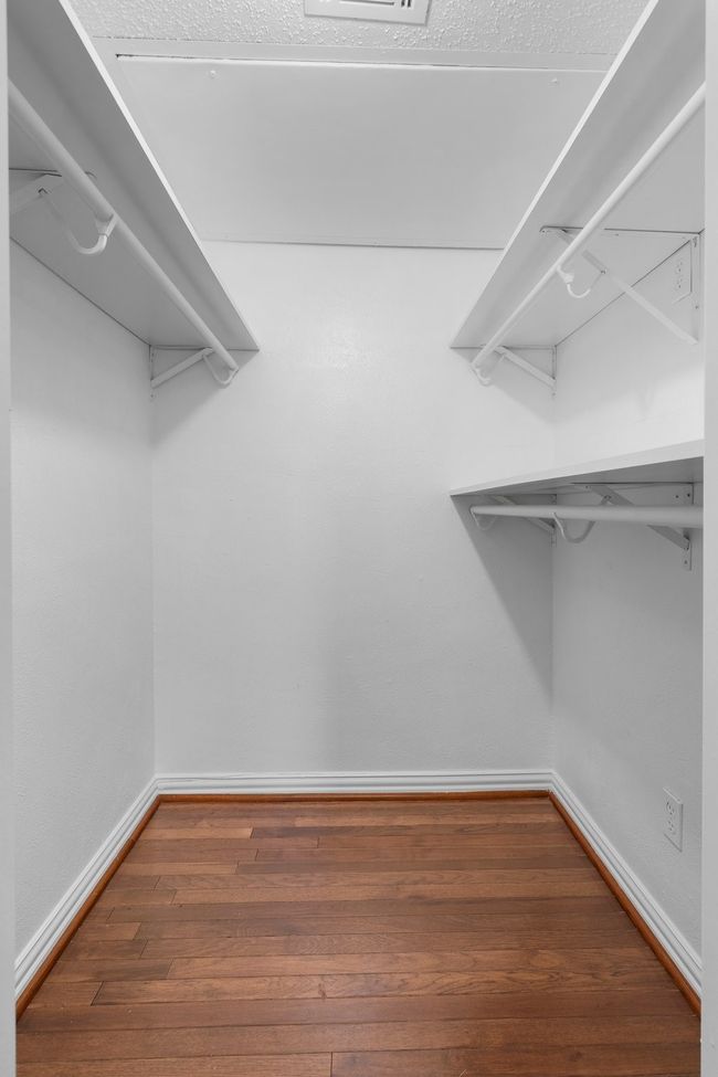 Spacious closet with wood finished floors | Image 25