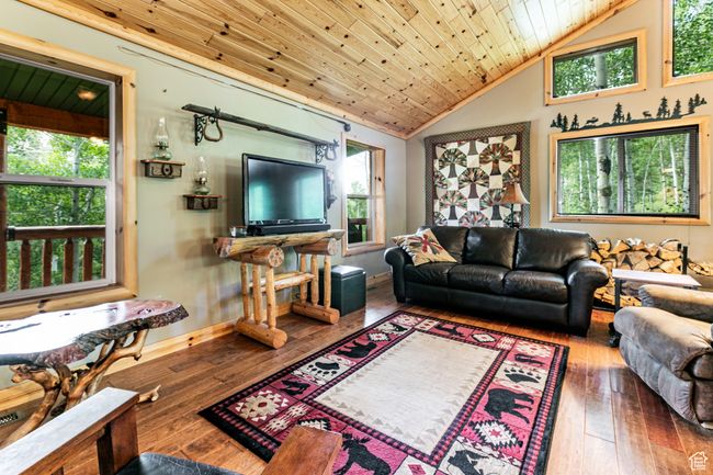 Living area featuring vaulted ceiling, hardwood / wood-style flooring, and wood ceiling | Image 9