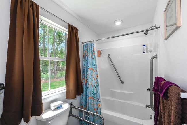 Full bathroom featuring toilet and shower / tub combo with curtain | Image 21