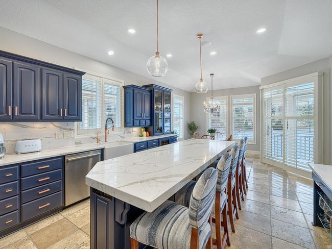 The kitchen flows into the informal dining area. | Image 8