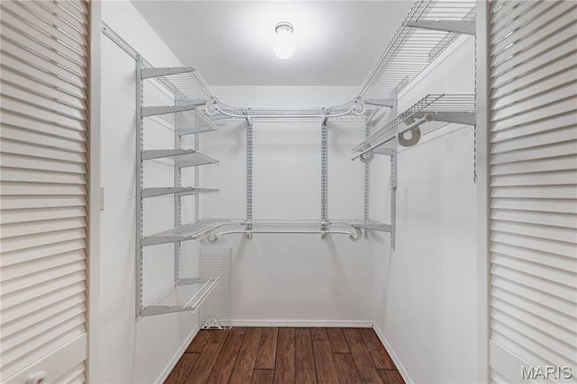 Walk in closet featuring wood finished floors | Image 37