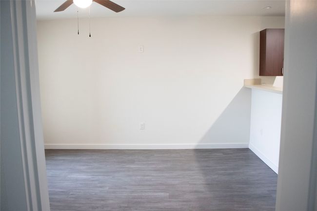 Empty room featuring baseboards, wood finished floors, and a ceiling fan | Image 4