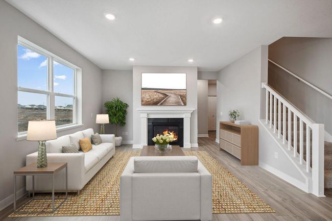 Spacious living room with electric fireplace (not shown). Model photo. Options and colors will vary. | Image 13