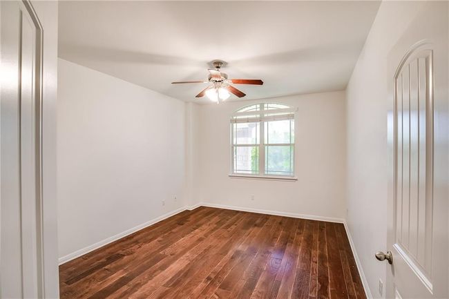 Unfurnished room with a ceiling fan and hardwood / wood-style floors | Image 21