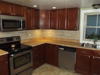 remodeled eat in kitchen with full bath and laundry on same floor. | Image 3