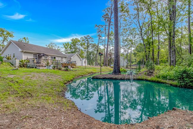 View of swimming pool with a wooden deck | Image 28