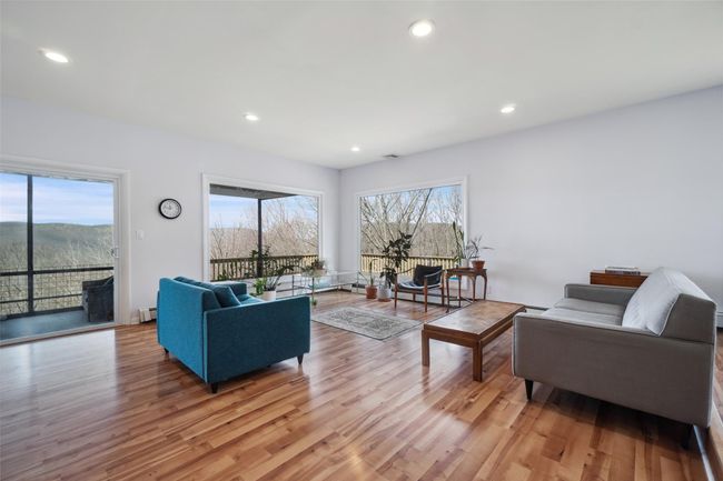 Living area with light wood finished floors and plenty of natural light | Image 7