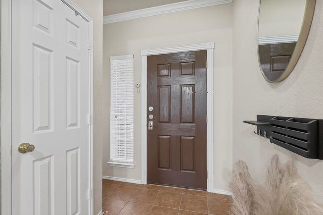 Tiled foyer with baseboards and ornamental molding | Image 7