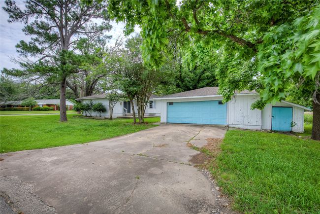 View of front facade featuring concrete driveway, a front yard, and a garage | Image 31