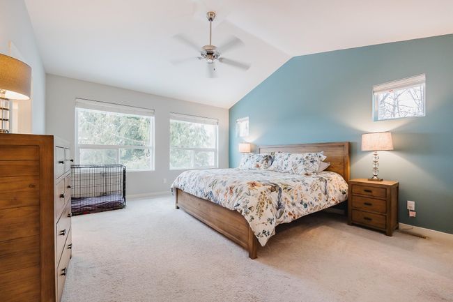 Bedroom with vaulted ceiling, a closet, a spacious closet, light carpet, and ensuite bath | Image 17