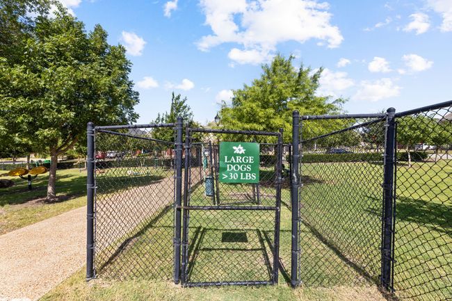View of community featuring a lawn, a gate, and fence | Image 37