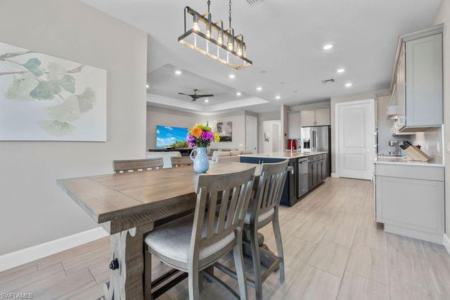 Dining space featuring visible vents, baseboards, recessed lighting, a raised ceiling, and a ceiling fan | Image 36