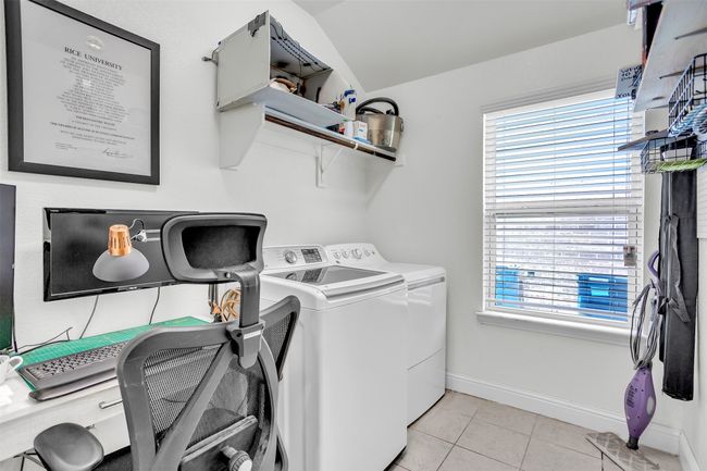 Laundry room with washer and dryer and light tile patterned floors | Image 25