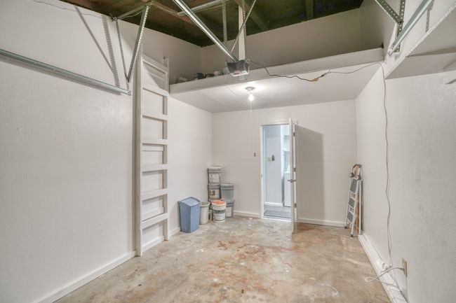 Garage with a garage door opener and loft area | Image 13
