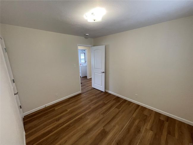 Empty room with baseboards and dark wood-style floors | Image 31