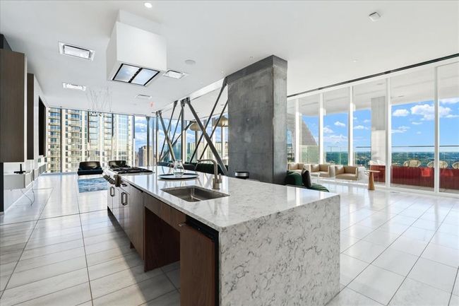 Amenity area for entertaining feat. Kitchen, dining, full gas range, TVs and expansive views. | Image 27
