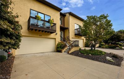 View of front facade with cooling unit, a balcony, and a garage | Image 3