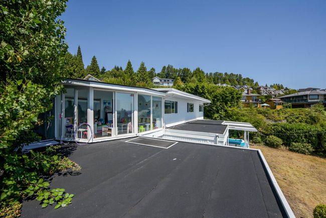 Back of property with uncovered parking and a sunroom | Image 16