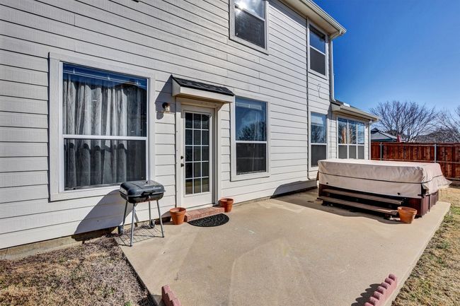 View of patio featuring fence, a hot tub, and grilling area | Image 6