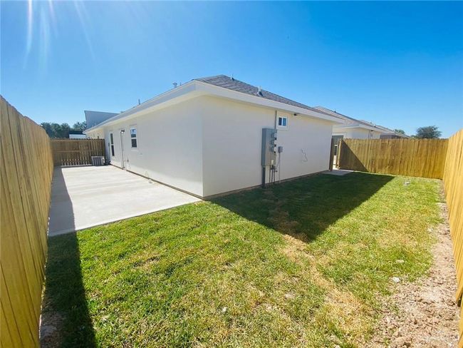 Rear view of property with a patio, a fenced backyard, and stucco siding | Image 14