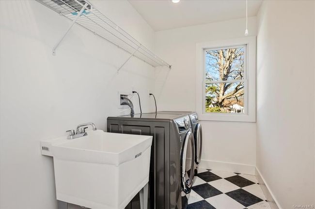 Laundry room featuring washer and clothes dryer and tile patterned floors | Image 21