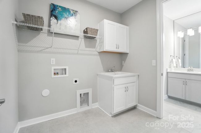 Laundry with doors to hall and Primary Bath | Image 28